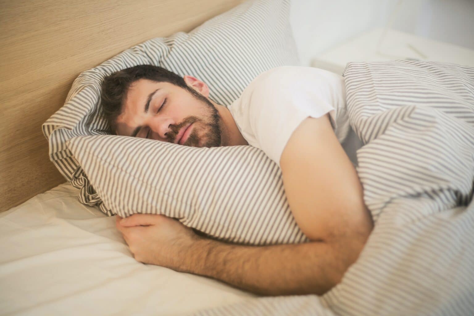 Man sleeping peacefully in bed.