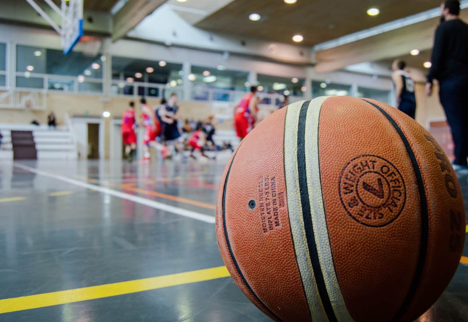 Close-up of a basketball in an indoor gym.