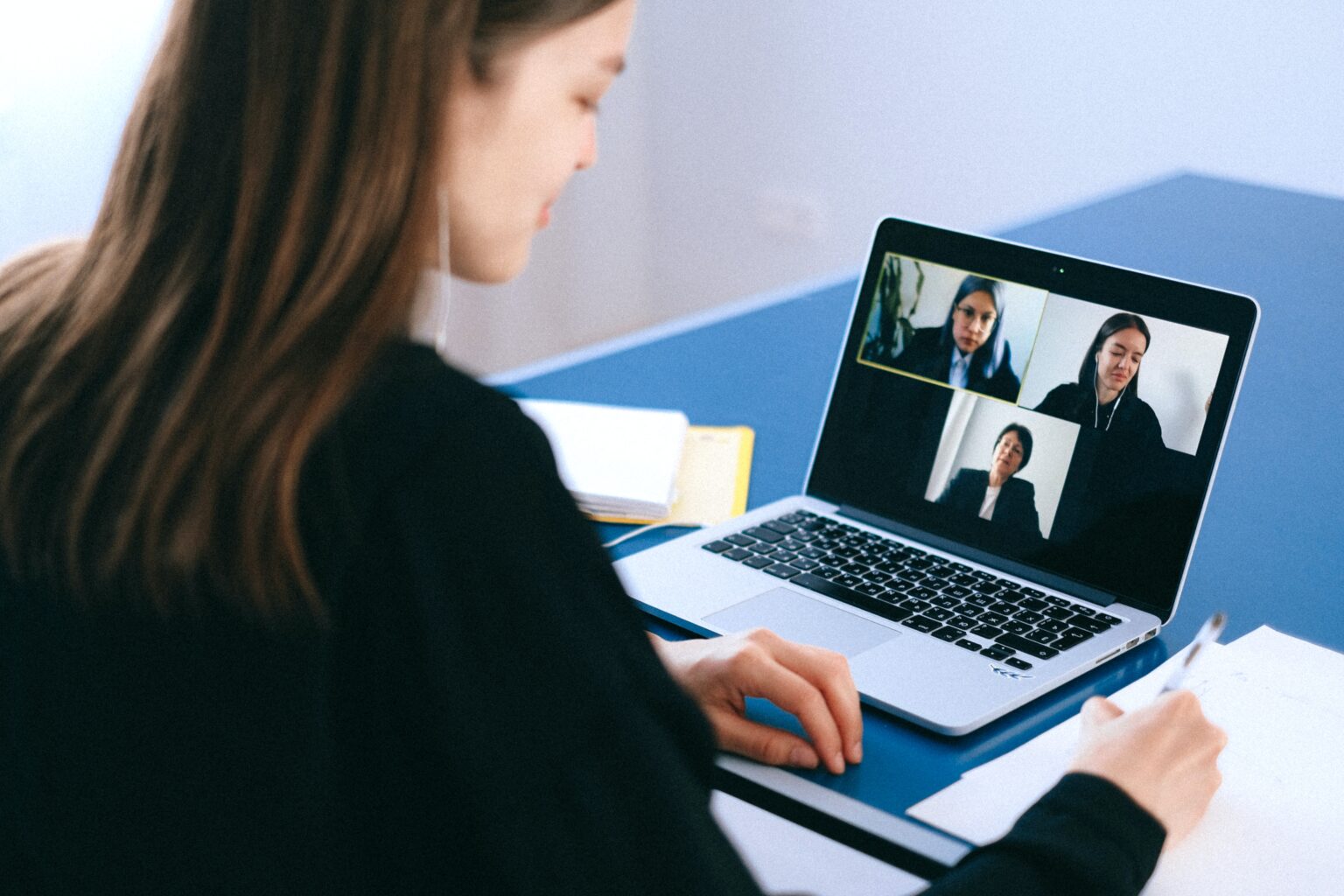 Woman using her laptop for a video meeting at work.