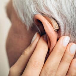 Audiologist examining hearing aid
