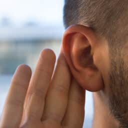 Close up hand to an ear