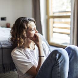 Woman with anxiety looking out the window