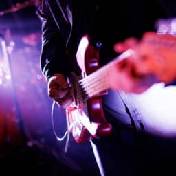 Close-up of a man playing a guitar at a concert