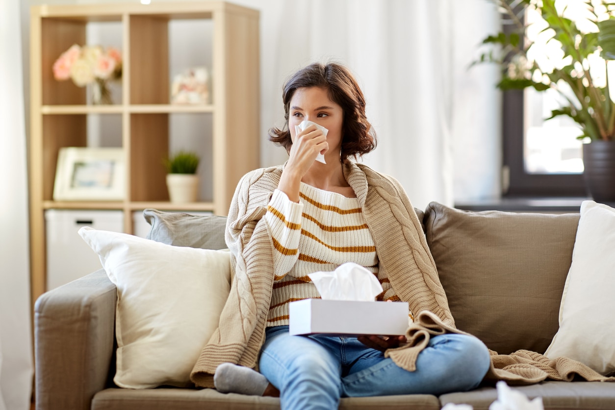 Woman sick with a viral infection rests at home